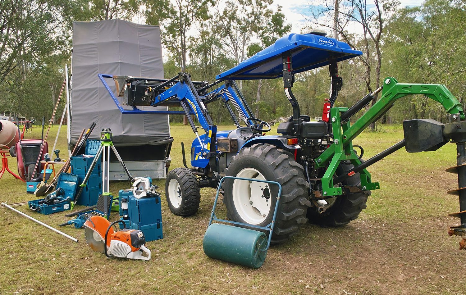 Holly Civil's New Holland tractor and post-hole auger set up on a job site near Jimboomba